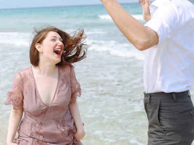 playful couple in front of the exotic sea at Sani Halkidiki Greece