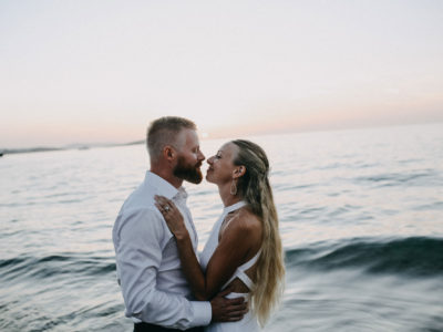 portrait by the sea of a new married couple in Greece