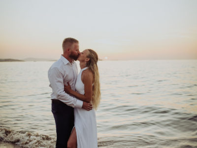 portrait by the sea of a new married couple in Greece