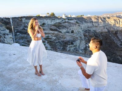 man proposing to a woman in Santorini island